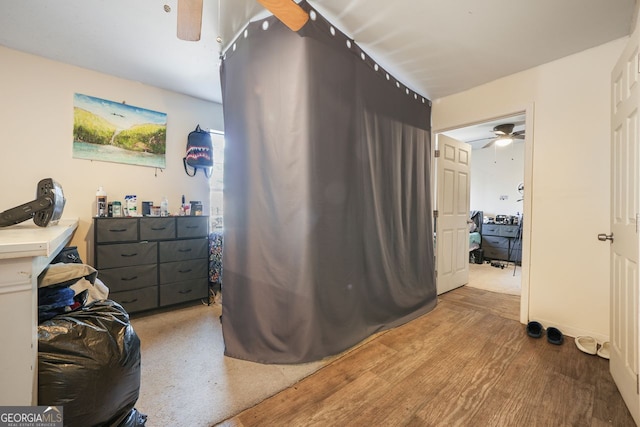 bedroom with ceiling fan and hardwood / wood-style floors