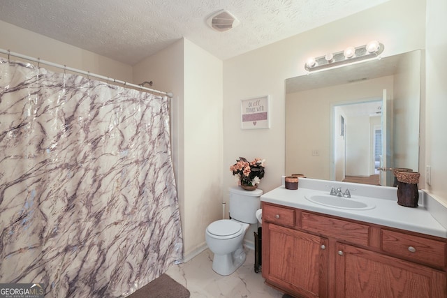 bathroom featuring a textured ceiling, toilet, and vanity