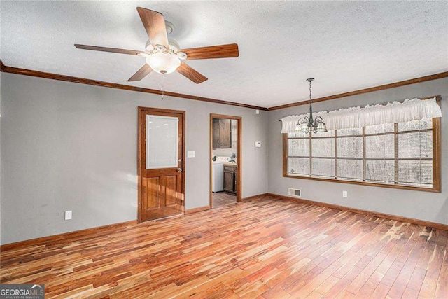 unfurnished room with ceiling fan with notable chandelier, hardwood / wood-style floors, a textured ceiling, washer / clothes dryer, and ornamental molding