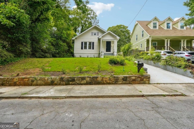 view of front of property with a front yard and covered porch