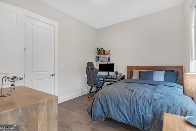 bedroom with dark hardwood / wood-style flooring