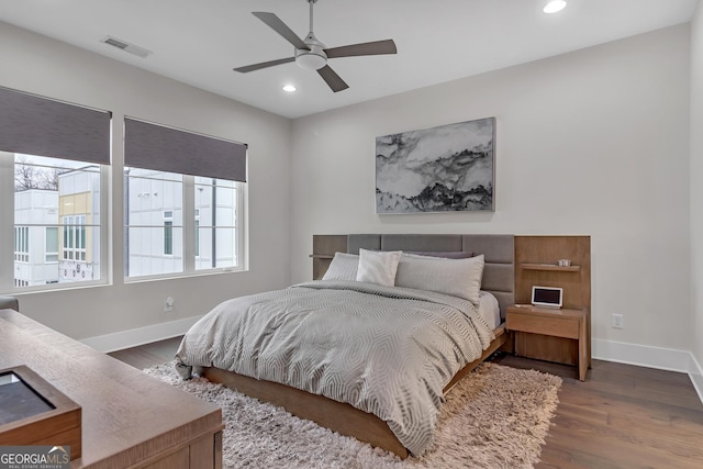 bedroom with ceiling fan and dark hardwood / wood-style floors