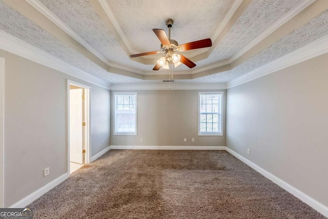 carpeted spare room featuring ceiling fan, crown molding, and a raised ceiling