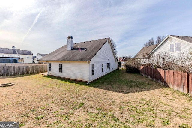 rear view of property with a yard