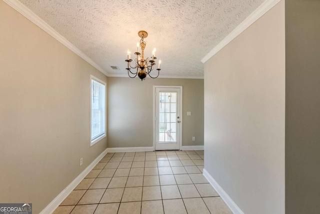 doorway with light tile patterned floors, an inviting chandelier, a textured ceiling, and ornamental molding