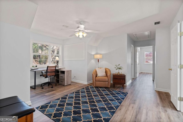 office space featuring ceiling fan, hardwood / wood-style floors, and vaulted ceiling