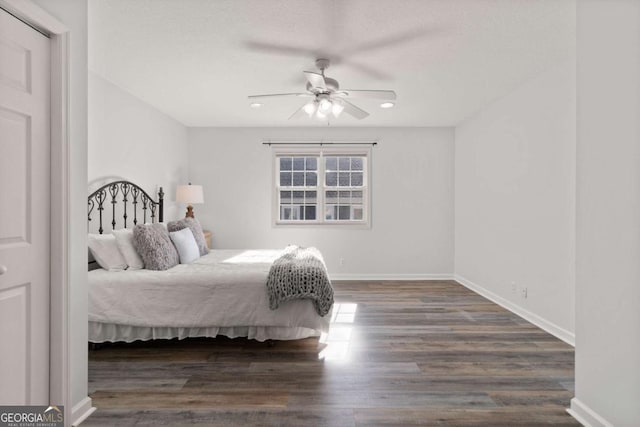 bedroom with ceiling fan and dark hardwood / wood-style floors