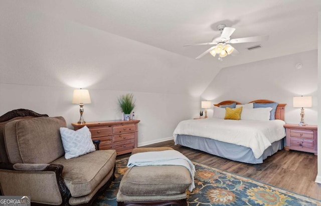 bedroom with ceiling fan, lofted ceiling, and dark hardwood / wood-style floors