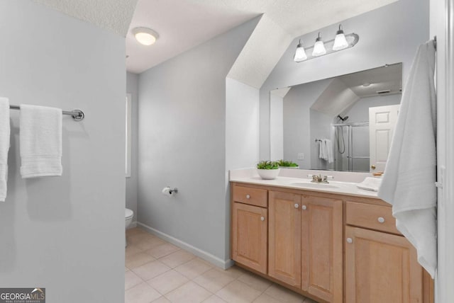 bathroom with a textured ceiling, tile patterned flooring, vanity, toilet, and a shower with shower door