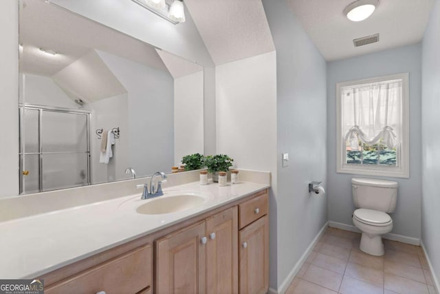 bathroom featuring toilet, a shower with shower door, tile patterned floors, vaulted ceiling, and vanity