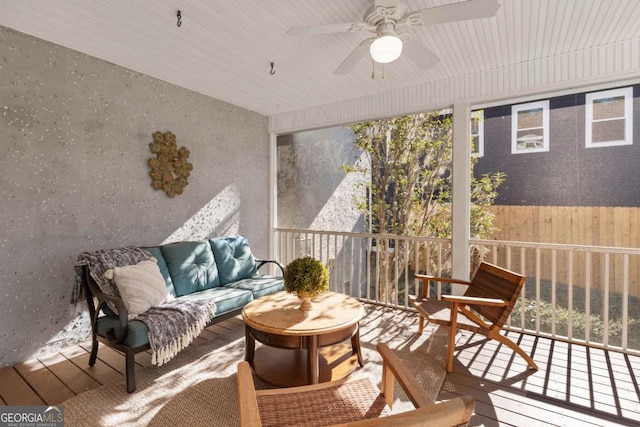 sunroom featuring ceiling fan