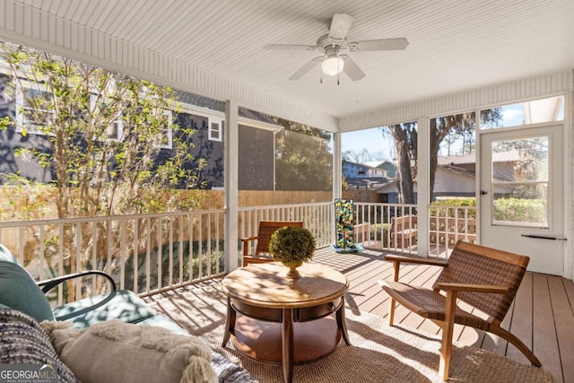 sunroom / solarium featuring ceiling fan