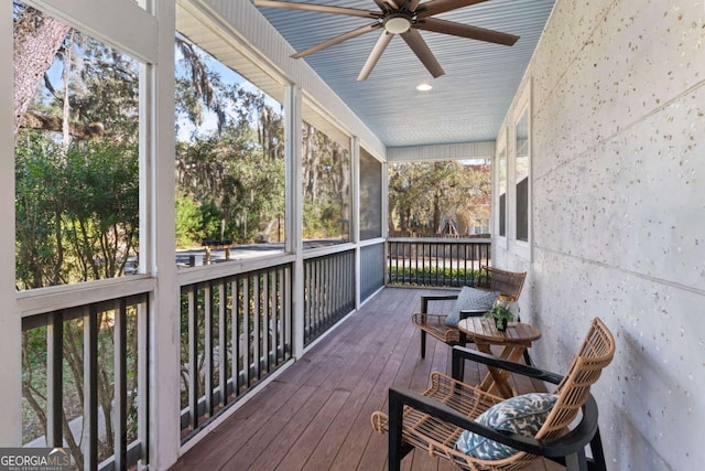 wooden terrace featuring ceiling fan