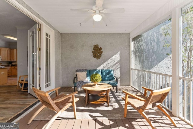 sunroom featuring ceiling fan