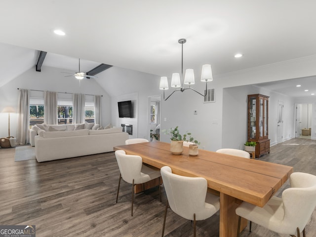 dining space featuring dark wood-type flooring, ceiling fan with notable chandelier, and vaulted ceiling with beams