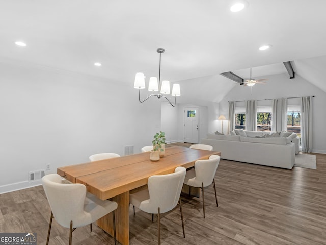 dining area with vaulted ceiling with beams, ceiling fan with notable chandelier, and hardwood / wood-style floors