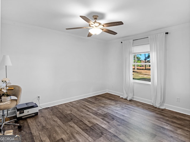 empty room featuring ceiling fan, crown molding, and dark hardwood / wood-style floors