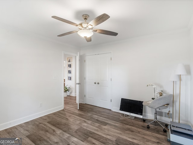 office area with dark wood-type flooring, crown molding, and ceiling fan