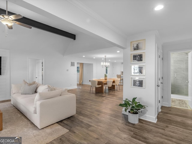 living room featuring dark wood-type flooring, ceiling fan with notable chandelier, crown molding, and beam ceiling