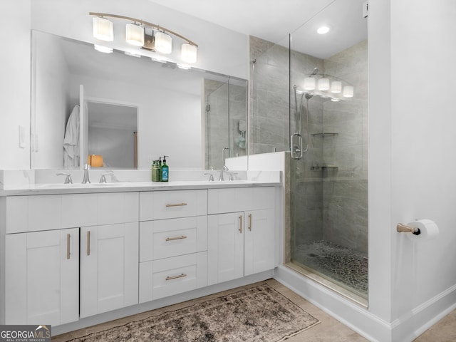 bathroom featuring a shower with shower door, vanity, and tile patterned floors