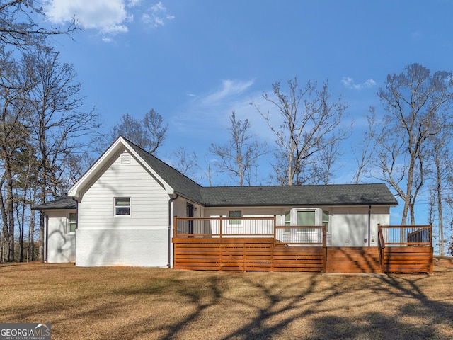 view of front of home with a wooden deck and a front yard