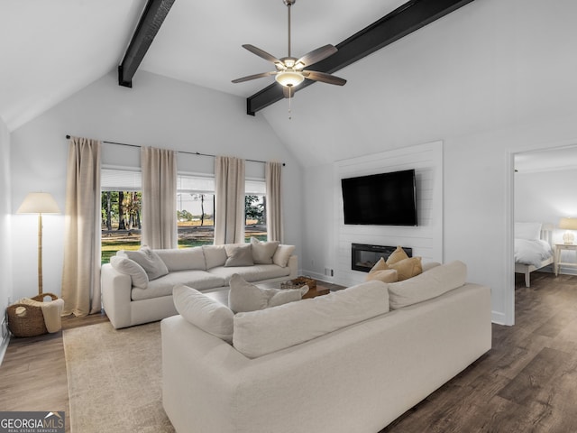 living room featuring ceiling fan, a fireplace, wood-type flooring, and lofted ceiling with beams