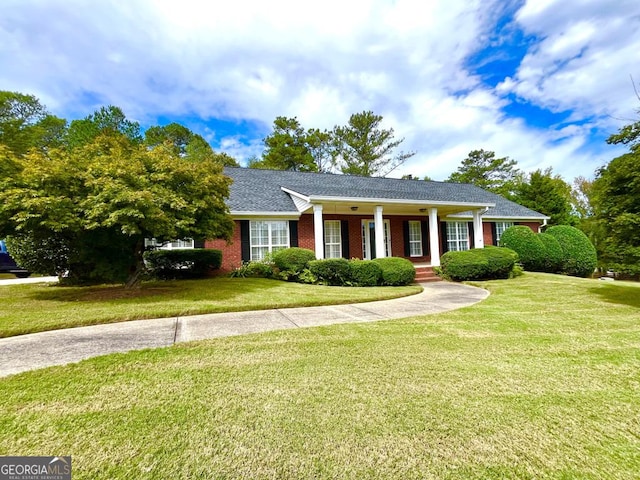 view of front of property with covered porch and a front yard