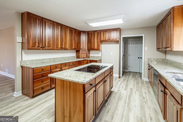 kitchen featuring a breakfast bar, kitchen peninsula, sink, light hardwood / wood-style flooring, and white microwave