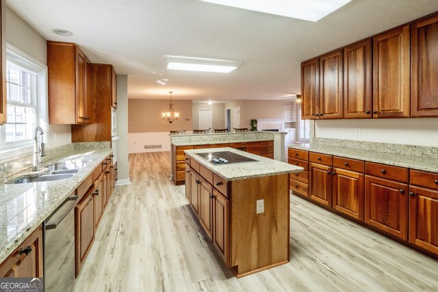 kitchen with light stone countertops and sink