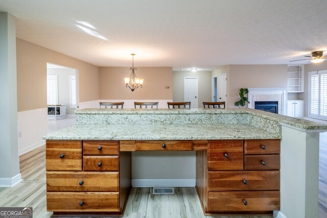 kitchen with light hardwood / wood-style floors, sink, white appliances, and light stone counters