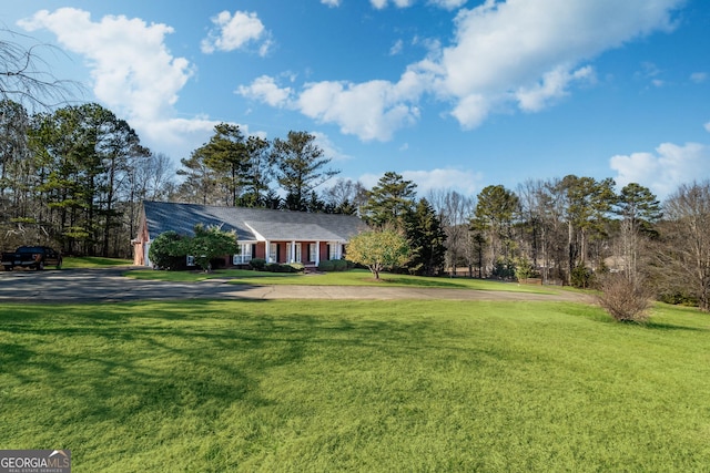 view of front of house with a front yard and driveway