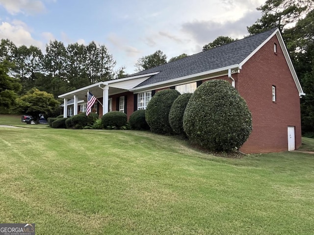 ranch-style home featuring a front yard