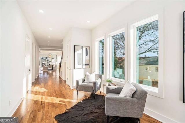 interior space featuring recessed lighting, baseboards, and light wood finished floors