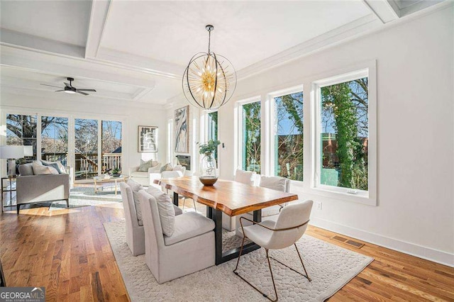 dining area with light wood-style floors, plenty of natural light, and baseboards