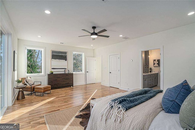 bedroom with light wood finished floors, visible vents, baseboards, and recessed lighting