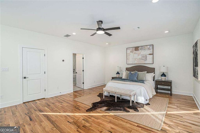 bedroom with recessed lighting, wood finished floors, visible vents, and baseboards