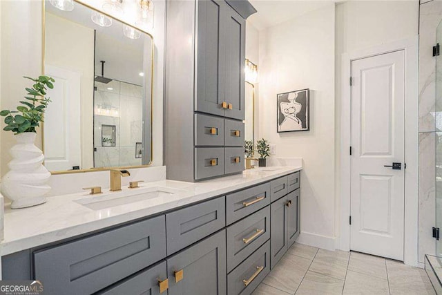 full bathroom featuring a stall shower, marble finish floor, a sink, and double vanity