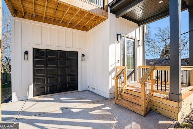 property entrance featuring a garage, crawl space, driveway, and board and batten siding