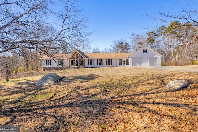 rear view of house with a lawn and a garage