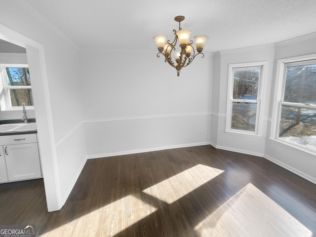 unfurnished dining area featuring a notable chandelier, dark wood-type flooring, and sink