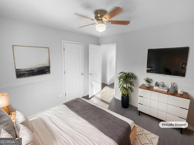 bedroom featuring ceiling fan and dark wood-type flooring