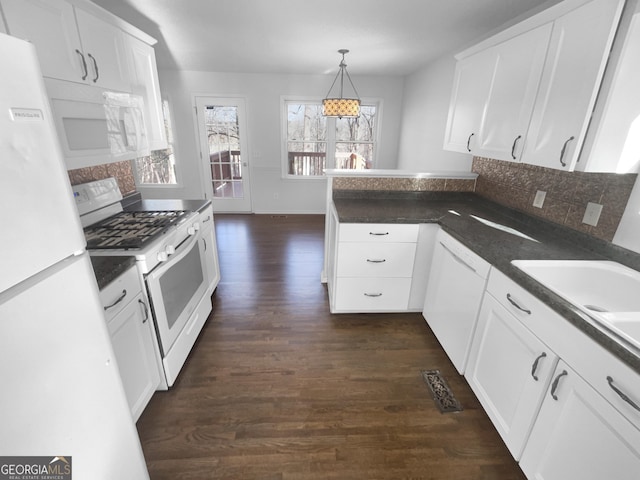 kitchen featuring dark wood-type flooring, white cabinetry, decorative light fixtures, and white appliances