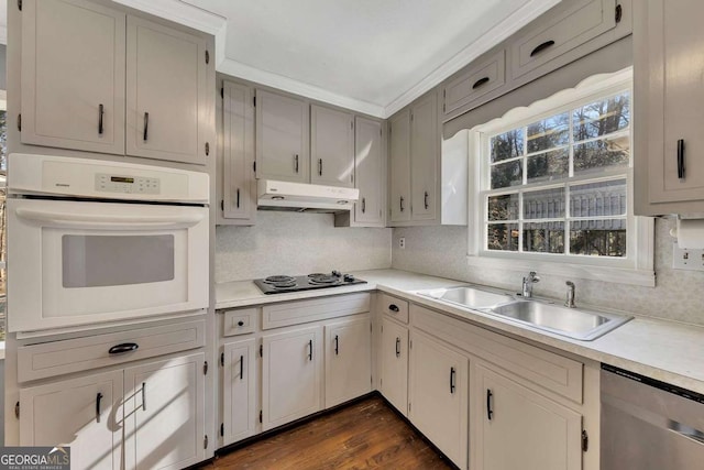 kitchen with black electric stovetop, sink, dark hardwood / wood-style floors, oven, and stainless steel dishwasher