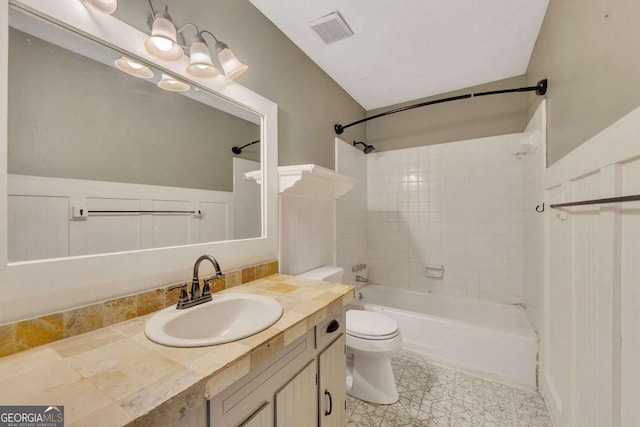 full bathroom with toilet, vanity, and tiled shower / bath combo