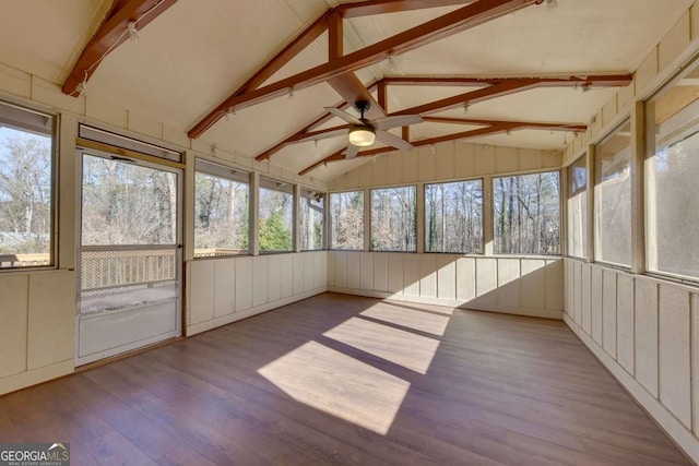 unfurnished sunroom with ceiling fan and vaulted ceiling with beams