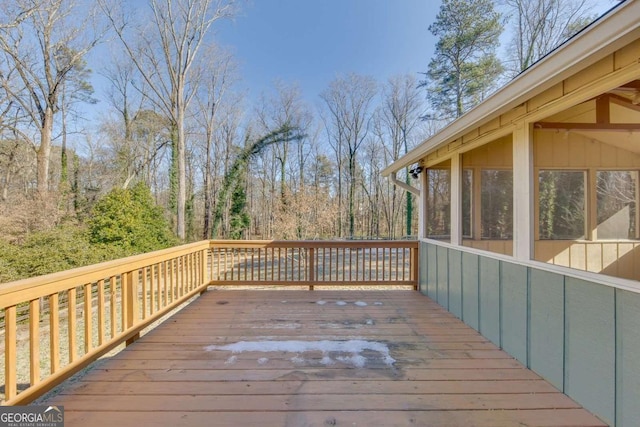 wooden deck with a sunroom