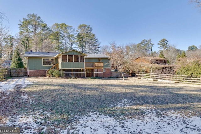 back of house featuring a sunroom