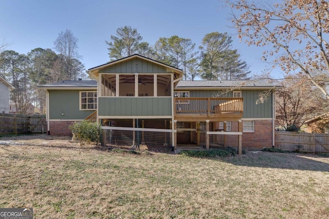 back of property featuring a lawn and a sunroom