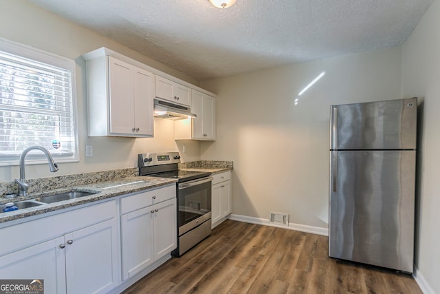 1883 La Mesa Ln, Decatur, GA 30032 - kitchen featuring sink, stainless steel appliances, light stone countertops, white cabinets, and dark hardwood / wood-style flooring