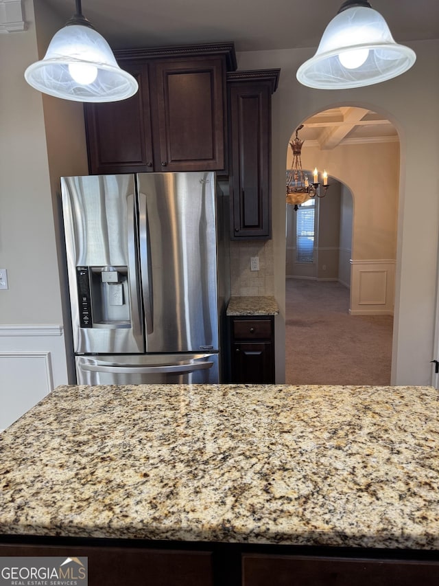 kitchen with carpet, an inviting chandelier, hanging light fixtures, stainless steel fridge with ice dispenser, and dark brown cabinets